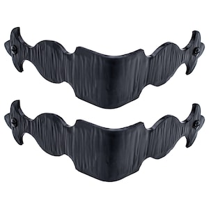 May include: Two black metal corner brackets with a decorative, ornate design. The brackets have a textured, hammered finish and are shaped like a curved, elongated S.