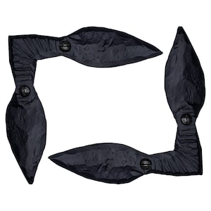 May include: Four black metal corner brackets with a leaf-like design. Each bracket has two visible screws.