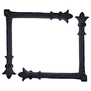 May include: Four black metal corner brackets with decorative scrollwork and a hammered finish. The brackets are designed to be used as decorative accents for furniture or other projects.