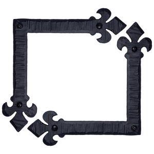 May include: Black metal corner brackets with a decorative fleur-de-lis design. The brackets are designed to be used for framing or decorative purposes.