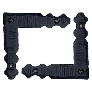 May include: Two black metal corner brackets with a textured surface and screw heads. The brackets are in the shape of a right angle and are joined together to form a square.