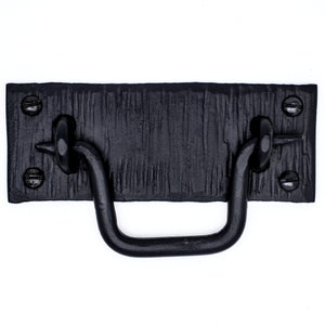 May include: Black metal cabinet pull with a rectangular base and a curved handle. The base has a textured finish and four visible screws.