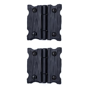 May include: Two black metal hinges with a textured surface. The hinges are closed and have visible screws.