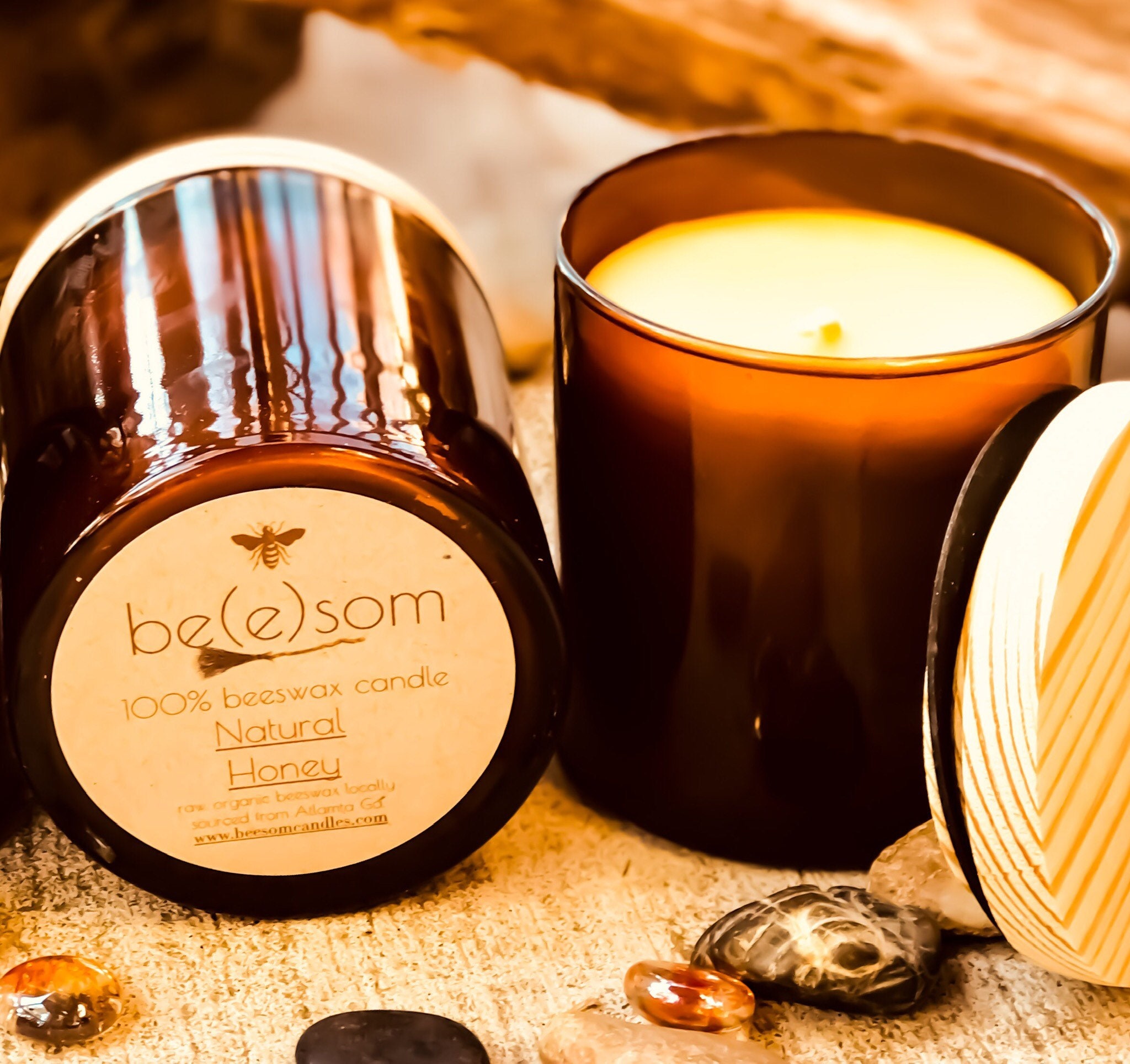Pure organic beeswax candle in an amber glass jar topped ...