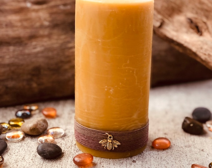 100% Pure Beeswax Pillar Candle wrapped in natural hemp cord and charmed with a golden Honeybee