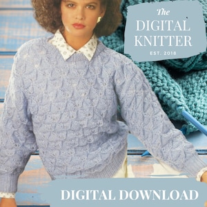 May include: A light blue knitted jumper with a textured pattern. The jumper has a round neckline and long sleeves. The image also includes a ball of teal yarn and knitting needles. The text "the DIGITAL KNITTER EST. 2018" is visible in the top right corner of the image. The text "DIGITAL DOWNLOAD" is visible at the bottom of the image.
