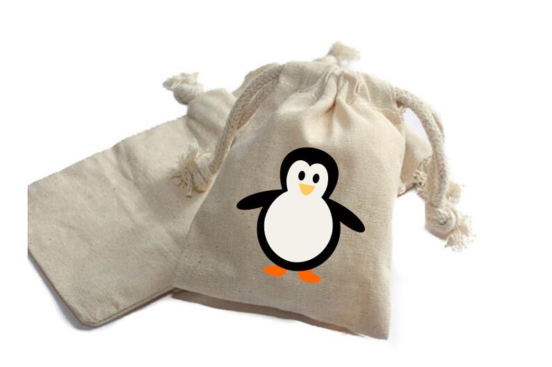 May include: Two small, natural-colored cotton drawstring bags. One bag has a black and white penguin design with an orange beak and feet.