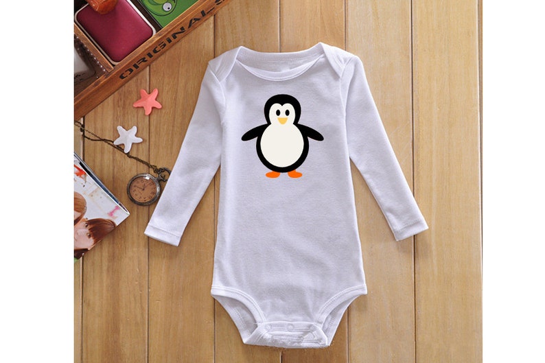 May include: White long-sleeved baby onesie with a cartoon penguin graphic. The penguin is black and white with orange feet.