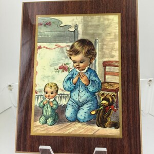 Vintage Placket With Young Child Kneeling for Prayers  1970’s