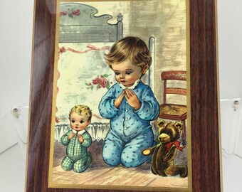 Vintage Placket With Young Child Kneeling for Prayers  1970’s