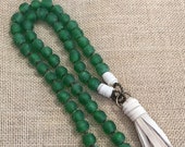 Green knotted African glass beads with beige deerhide tassel