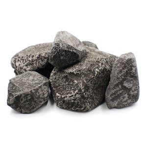 May include: A group of five dark gray rocks with a rough, textured surface. The rocks are arranged in a pile, with the largest rock in the center.