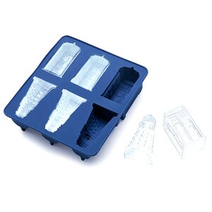 May include: Blue silicone ice cube tray with molds of the Doctor Who TARDIS and Dalek. The tray is filled with clear ice cubes shaped like the TARDIS and Dalek.