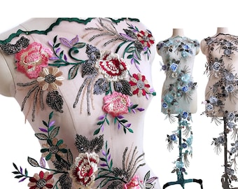 May include: Three floral appliques on a mesh background. The first applique is a cluster of pink, red, and yellow flowers with green leaves and black beads. The second applique is a cluster of blue flowers with green leaves and silver beads. The third applique is a cluster of gray flowers with green leaves and silver beads.