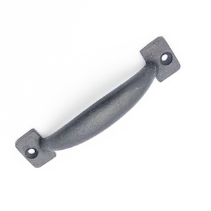 May include: Black metal cabinet pull handle with a rounded shape and square ends. The handle has two holes for mounting.