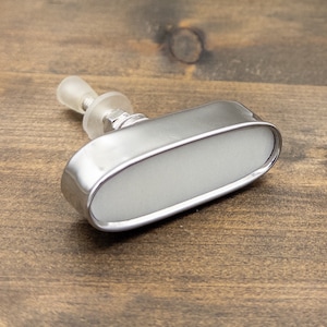 May include: A silver oval-shaped cabinet knob with a clear plastic knob on top.