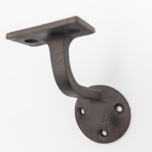 May include: Black metal handrail bracket with a square top plate and a round base with four screw holes.