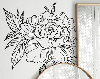May include: A white wall with a black and white floral decal, a round wooden framed mirror, and a tall rectangular wooden framed mirror. Two potted plants are in the foreground.
