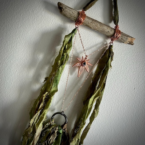 Real leaves transformed into copper through electroforming — wearable botany meets alchemy, no two pieces are identical.