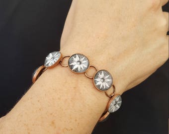 black and white flower bracelet in copper setting with glass cabochons