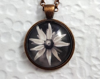black and white wildflower image on copper pendant with glass cabochon and rolo chain