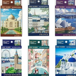 May include: A collection of six 100-piece Dinky Jigsaw puzzles, each depicting a famous world landmark. The images include the Taj Mahal, Eiffel Tower, Sydney Opera House, Big Ben, Venice canals, and Greek architecture. Each box reads "Dinky Jigsaws World Traveller".