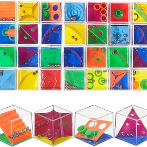 May include: A selection of colourful maze puzzles in clear plastic cubes. Each cube has a unique design with coloured plastic elements and small metal balls. The puzzles are arranged in a grid, showcasing various challenges.