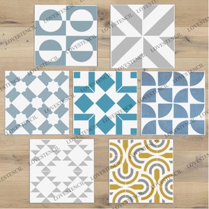 May include: Six different tile stencils featuring geometric patterns. The stencils are white with blue, grey, and yellow designs. The stencils are displayed on a wooden background.
