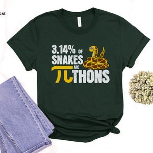 May include: A dark green t-shirt with a white graphic that says "3.14% of snakes are pi-thons". The graphic also includes a cartoon snake.