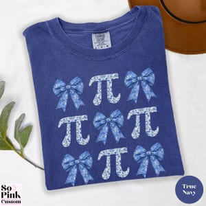 Comfort Colors®  Coquette blue toile de jouy pi shirt with bows and pi symbols laid out in a 3 x 3  grid