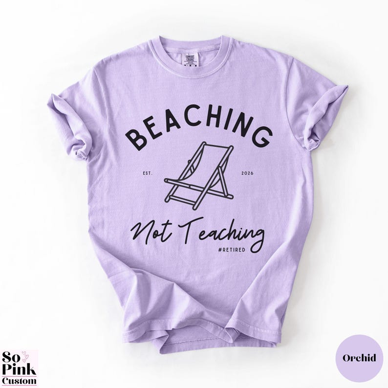 Comfort Colors Shirt with deck chair illustration in the center, curved text above, script below - BEACHING Not Teaching #Retired Year Est. 2026