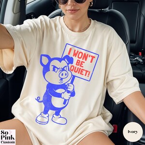 Comfort Colors Shirt with retro cartoon pig holding a protest sign with text I Won't Be Quiet!
