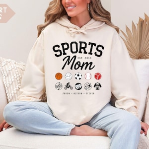 Multiple Sports Mom Hooded Sweatshirt with various sports ball icons, year established and kids names, mixture of college and cursive fonts
