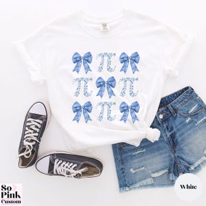Comfort Colors®  Coquette blue toile de jouy pi shirt with bows and pi symbols laid out in a 3 x 3  grid