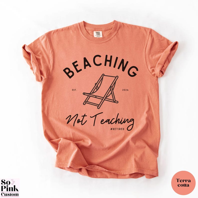 Comfort Colors Shirt with deck chair illustration in the center, curved text above, script below - BEACHING Not Teaching #Retired Year Est. 2026