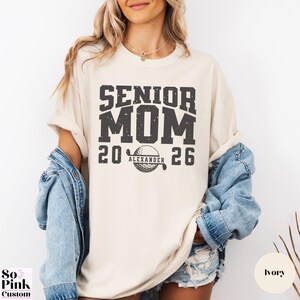 Comfort Colors Senior Golf Mom Shirt Personalized with Name and Year, bold collegiate font with golf ball monogram, distressed graphic
