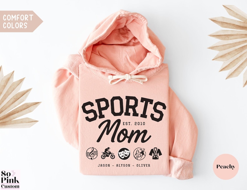 Multiple Sports Mom Hooded Sweatshirt with various sports ball icons, year established and kids names, mixture of college and cursive fonts