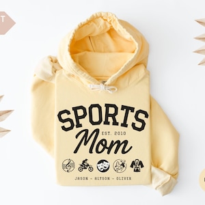 Multiple Sports Mom Hooded Sweatshirt with various sports ball icons, year established and kids names, mixture of college and cursive fonts