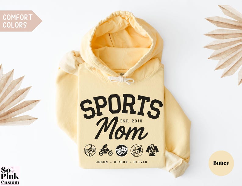 Multiple Sports Mom Hooded Sweatshirt with various sports ball icons, year established and kids names, mixture of college and cursive fonts