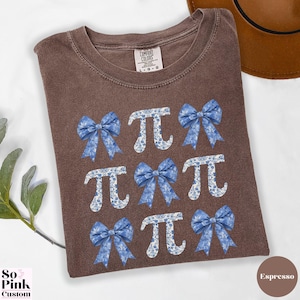 Comfort Colors®  Coquette blue toile de jouy pi shirt with bows and pi symbols laid out in a 3 x 3  grid