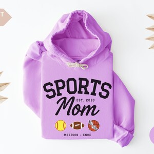 Multiple Sports Mom Hooded Sweatshirt with various sports ball icons, year established and kids names, mixture of college and cursive fonts