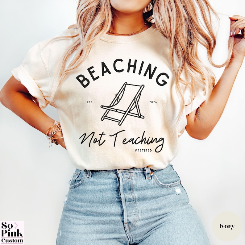 Comfort Colors Shirt with deck chair illustration in the center, curved text above, script below - BEACHING Not Teaching #Retired Year Est. 2026