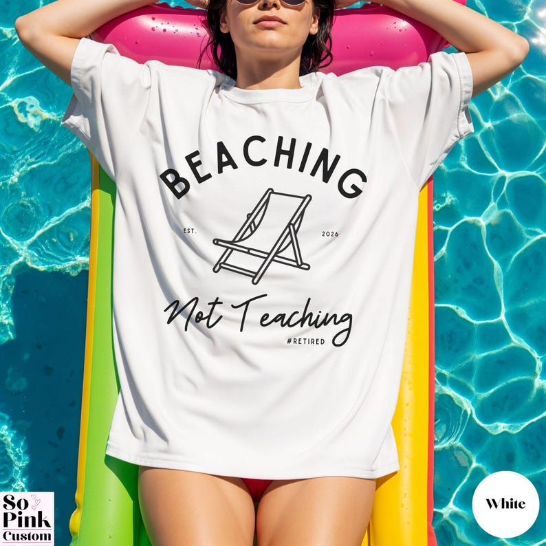 Comfort Colors Shirt with deck chair illustration in the center, curved text above, script below - BEACHING Not Teaching #Retired Year Est. 2026