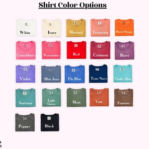 May include: A grid of twenty-two t-shirts in various colors labeled with text including White, Ivory, Mustard, Terracotta, Burnt Orange, Crunchberry, Watermelon, Red, Crimson, Berry, Violet, Blue Jean, Flo Blue, True Navy, Chalky Mint, Seafoam, Light Green, Moss, Yam, Espresso, Pepper, and Black. The header reads Shirt Color Options and the bottom left corner displays the text So Pink Custom.