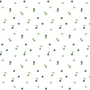 May include: A white fabric featuring a scattered pattern of small, three-leaf shamrocks in varying shades of dark and light green. A ruler at the bottom indicates a width of 12 inches, with the text Riley Blake Designs printed on it.