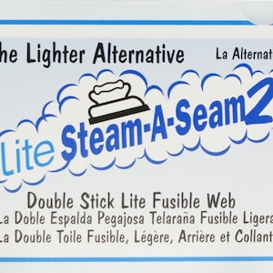 May include: A package of Steam-A-Seam2 Lite Fusible Web, a lighter alternative to traditional fusible web. The package features a blue and white design with the product name and logo. The text on the package reads "The Lighter Alternative", "La Alternativa más Ligera", and "L' Alternative plus Légère".