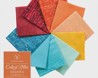 May include: A collection of ten folded fabric squares arranged in a circular fan pattern, featuring shades of red, orange, yellow, and teal. The Windham Fabrics Color Me Sedona label is visible, noting the bundle contains 10 fat quarters.