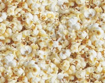 May include: A close-up image of a large bowl of popcorn. The popcorn is white and yellow and appears to be freshly popped.