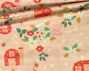 May include: A pink fabric with a repeating pattern of red barns, white flowers, and green leaves. The fabric has a subtle texture.