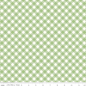 May include: A green and white gingham fabric with a repeating pattern of squares. The fabric is measured in inches.
